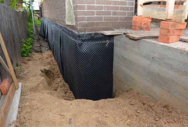 SJ Waterproofing Pros technician performing targeted Basement Waterproofing assessment in Bunker Hill, IN